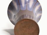 a blue and white bowl and a penny on a white surface