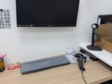 a desk with a keyboard, mouse and a monitor on it