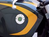 a close up of a motorcycle with a green and yellow stripe