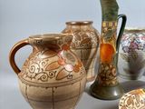 many different vases and plates on the table