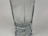 a glass vase on a white table with a white background