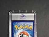 a close up of a pokemon card in a plastic case