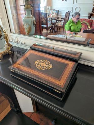 a black table with a mirror and a clock on it