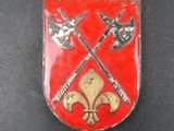 a close up of a red and gold shield with two crossed swords