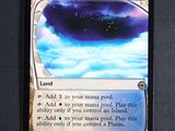 a close up of a card on a table with a sky background