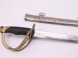 two different types of knives on a white surface