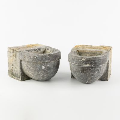 pair of gray stone bowls with handles on a white background