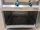 a stainless steel oven with two blue knobs on it