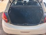 the back of a white car with its trunk open in a parking lot