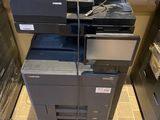 a stack of printers sitting on top of each other in a room
