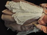 a doll that is laying down on a black surface