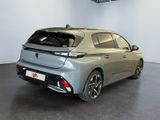 the rear end of a silver car in a showroom