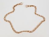 un bracelet en chaîne d'or avec un maillon et un fermoir sur fond blanc
