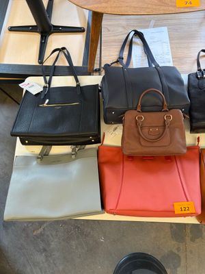 a lot of purses that are on a table