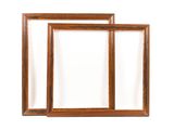 two wooden picture frames on a white wall with a white background