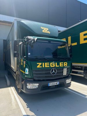 two trucks parked next to each other in front of a building