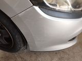 a close up of a car ' s front bumper and headlight