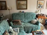 un salon avec un canapé vert et une table basse