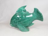 a green ceramic fish figurine on a white background