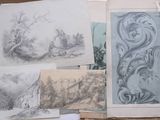 a pile of drawings sitting on top of a table