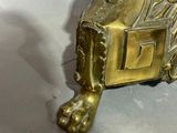 brass plated table with a lion head on the top of it