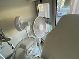 a room with two fans and a chair in it