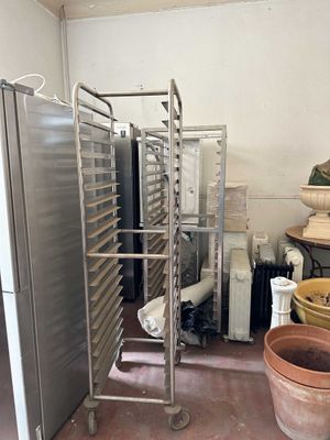 a metal rack with a bunch of trays on it