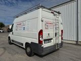 a white van parked in front of a building