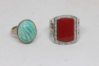 two rings, one with a red stone and one with a turquoise stone