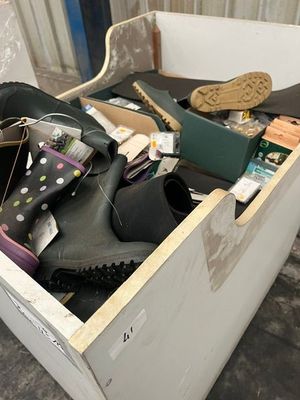 a box full of shoes and a pair of shoes in it
