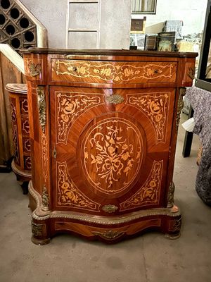 a wooden cabinet with a floral design on it