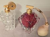 two perfume bottles sitting next to each other on a table