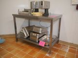 an image of a kitchen with a table with pans on it