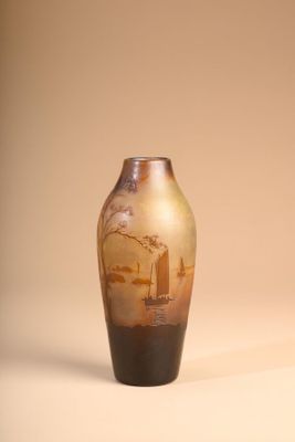 a vase with a painting on it sitting on a table