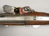 an old gun with a wooden barrel and a metal handle
