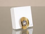 an image of a gold and diamond ring on a white box