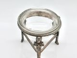 an antique silver plate on a stand on a white background