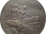 an old silver medal with a man and a woman sitting on a bench