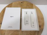 a white box that is open on a wooden table