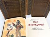two books are open on a table with a picture of a man and a woman