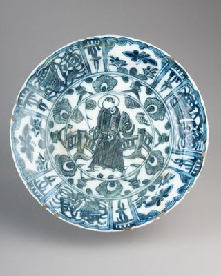 blue and white plate with a design of a man on a horse and a man on a horse