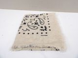 bandana with a black and white design on it sitting on a white surface
