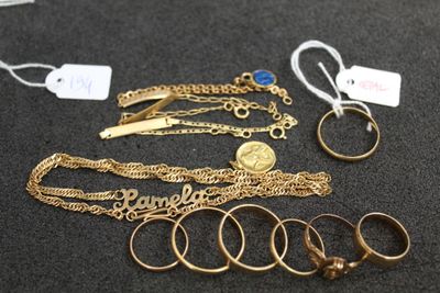 a lot of gold rings and bracelets on the table