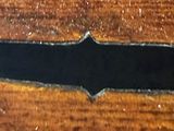 a close up of a wooden table with a black stripe