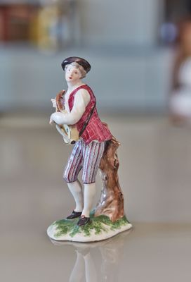 a figurine of a man with a dog on a table