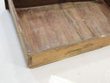 a small wooden box with a handle on a table