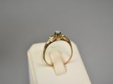 an image of a gold ring with a diamond on top of a white box