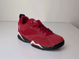 a close up of a pair of red sneakers on a white surface