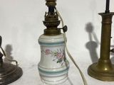 three antique lamps that are sitting on a table