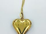a gold heart shaped locke on a gold chain